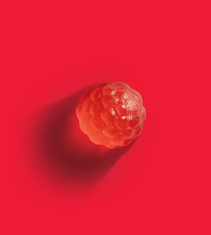 Close up of a single raspberry Enhancd Sleep gummy