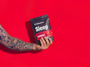 Hand holding a pouch of Enhancd Sleep Gummies